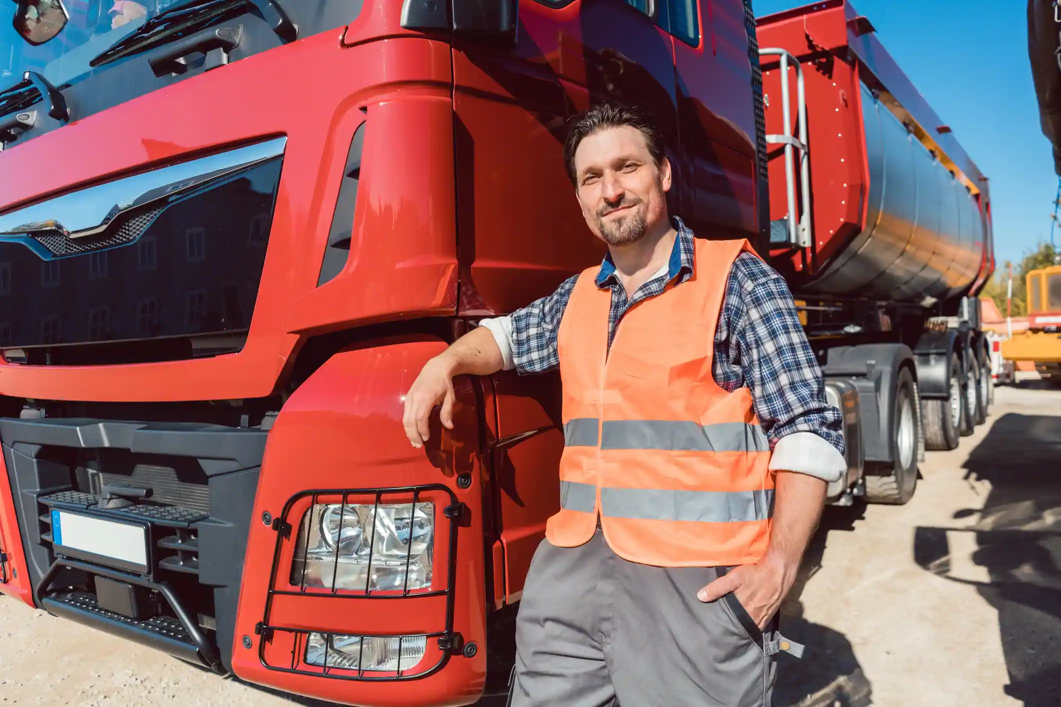 Truck driver in front of his freight forward lorry